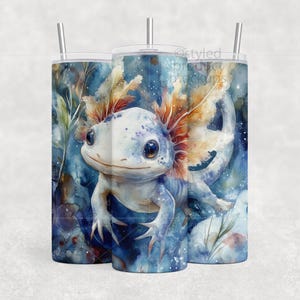 May include: Three 20 oz. stainless steel tumblers with a watercolor axolotl design. The axolotl is light blue with orange gills and is set against a blue and white background. Each tumbler has a silver straw and a clear lid.