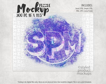 May include: A white jigsaw puzzle mockup with a purple and blue watercolor design featuring the text "SPM" and "Styled Product Mockups". The puzzle is 300 pieces and measures 16 x 11.5 inches.