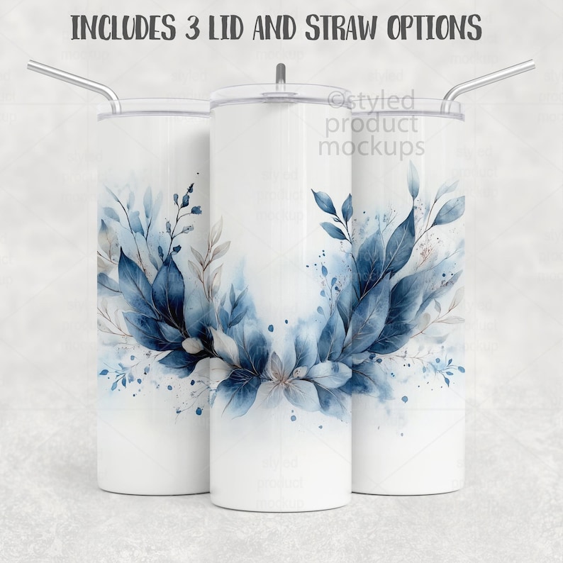 May include: Three white insulated tumblers with a floral design in shades of blue and gray. Each tumbler has a different lid and a silver straw. The text at the top reads "INCLUDES 3 LID AND STRAW OPTIONS."