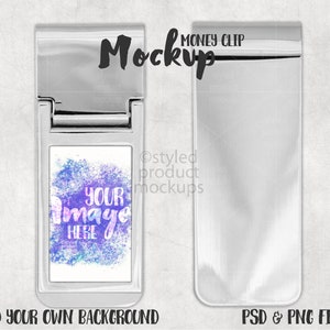May include: A silver money clip mockup with a blank space for adding a design. The clip is open and the blank space is filled with a watercolor design of purple, blue, and pink colors. The text "YOUR image HERE" is written on the design. The text "MONEY CLIP" is written above the clip. The text "ADD YOUR OWN BACKGROUND" is written below the clip. The text "PSD & PNG FILES" is written below the clip on the right side.
