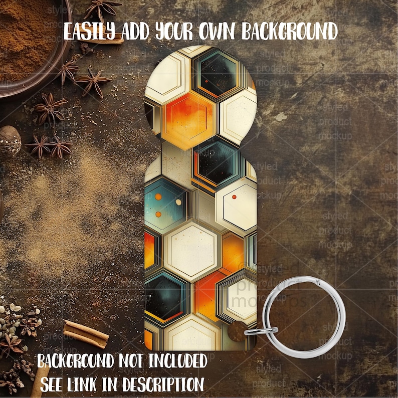 May include: A key chain with a geometric design of hexagons in orange, cream, and teal. The key chain has a silver-colored ring. The text "EASILY ADD YOUR OWN BACKGROUND" and "BACKGROUND NOT INCLUDED SEE LINK IN DESCRIPTION" are visible.