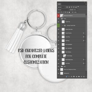 May include: A silver keychain with a round, blank pendant and a white tassel. The text "PSD ORGANIZED LAYERS FOR COMPLETE CUSTOMIZATION" is printed on the pendant. A digital interface with layers is visible in the background.