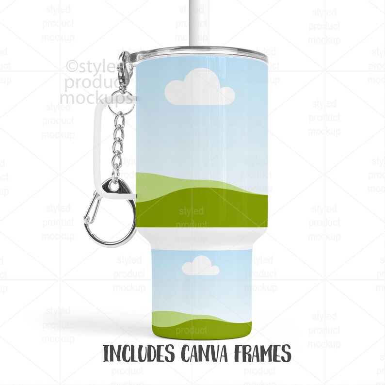 May include: A white tumbler with a landscape design featuring blue skies, white clouds, and green hills. The tumbler includes a white straw, a silver carabiner clip, and the text "INCLUDES CANVA FRAMES".