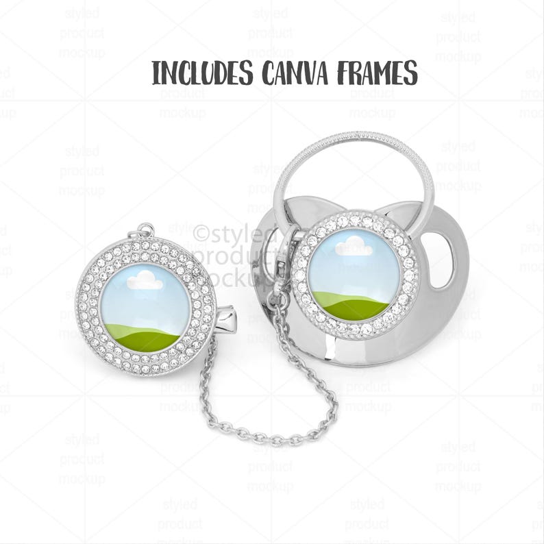May include: A silver pacifier and clip set with a chain. Each piece has a round, clear center with a landscape scene and is surrounded by a ring of small, clear crystals. The text "INCLUDES CANVA FRAMES" is at the top.