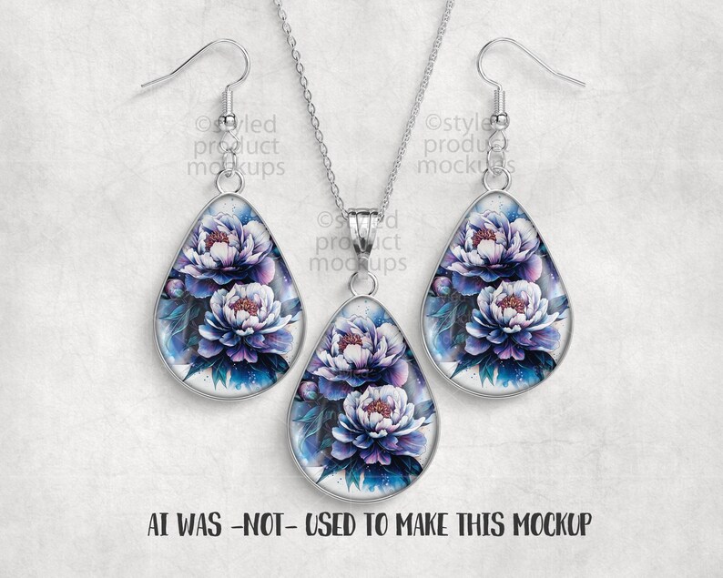 May include: A jewelry set featuring a pendant necklace and matching earrings. Each piece has a teardrop shape with a floral design in shades of purple, white, and blue. The text "AI WAS -NOT- USED TO MAKE THIS MOCKUP" is at the bottom.