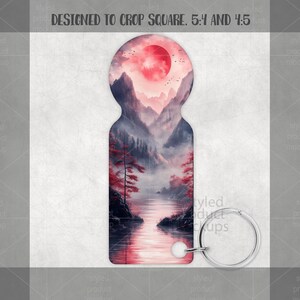 May include: Keyring with a landscape design featuring a red sun, mountains, and a river. The keyring has a silver-colored ring and a white bead. The text "DESIGNED TO CROP SQUARE. 5:4 AND 4:5" is at the top.