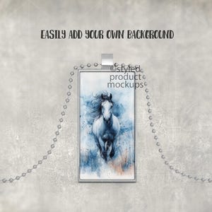 May include: A silver chain necklace with a rectangular pendant featuring a watercolor painting of a white horse running through a blue and white landscape.