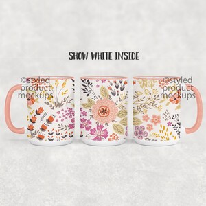 May include: Three white ceramic mugs with pink rims and handles. Each mug features a different floral pattern in shades of pink, orange, and yellow. The text "Show White Inside" appears above the mugs.