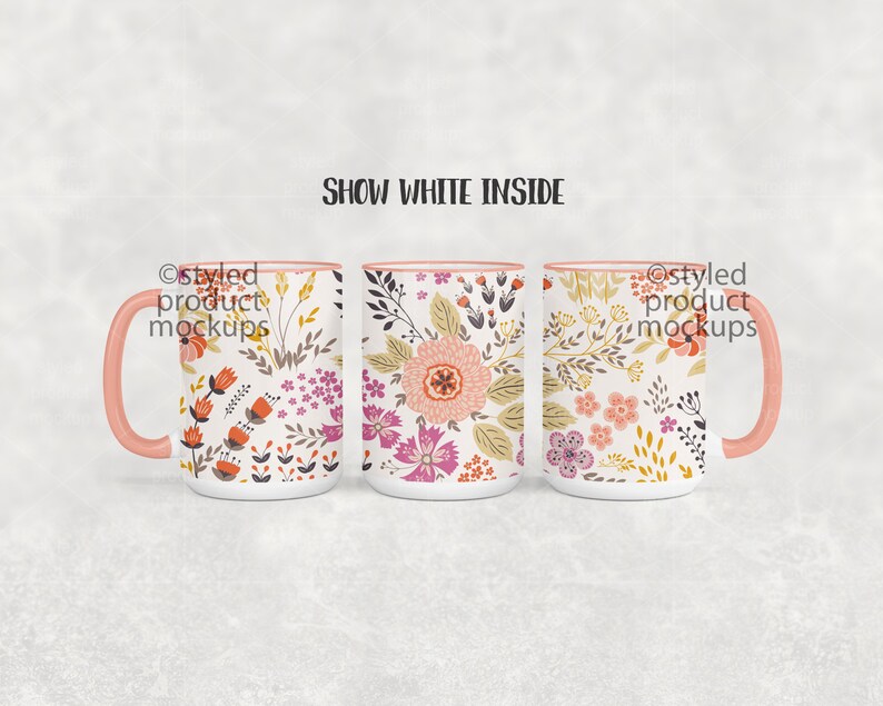 May include: Three white ceramic mugs with pink rims and handles. Each mug features a different floral pattern in shades of pink, orange, and yellow. The text "Show White Inside" appears above the mugs.