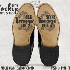 May include: A pair of black leather groom's shoes with light brown soles. The soles feature the text "YOUR IMAGE HERE" and floral designs. The image also includes the text "Mockup GROOM'S SHOES" and "ADD YOUR OWN BACKGROUND PSD & PNG FILES."