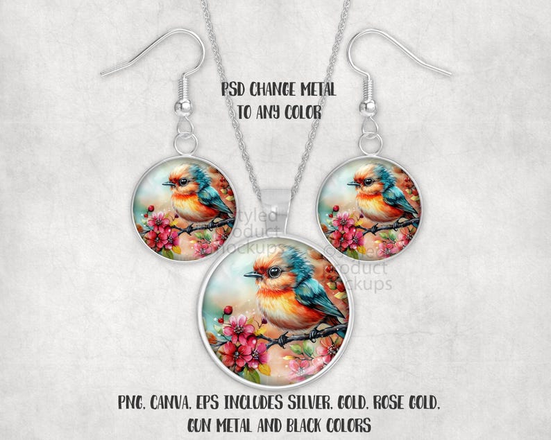 May include: A silver-toned jewellery set comprising a pendant necklace and earrings. Each piece showcases a watercolour image of a colourful bird on a flowering branch within a round frame. The image text reads "PSD CHANGE METAL TO ANY COLOR".
