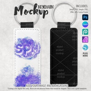 May include: Mockup of a white and black leather keychain with a silver ring. The white keychain has a purple and blue watercolor design with the letters "SPM" in a circle. The black keychain has a textured leather surface.