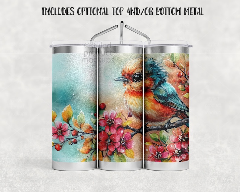 Peut inclure: Gobelet en acier inoxydable avec un motif aquarelle repr&eacute;sentant un oiseau color&eacute; perch&eacute; sur une branche avec des fleurs roses et des baies. Le gobelet a un couvercle argent&eacute; et une paille en m&eacute;tal. Le texte en haut dit : "INCLUDES OPTIONAL TOP AND/OR BOTTOM METAL."