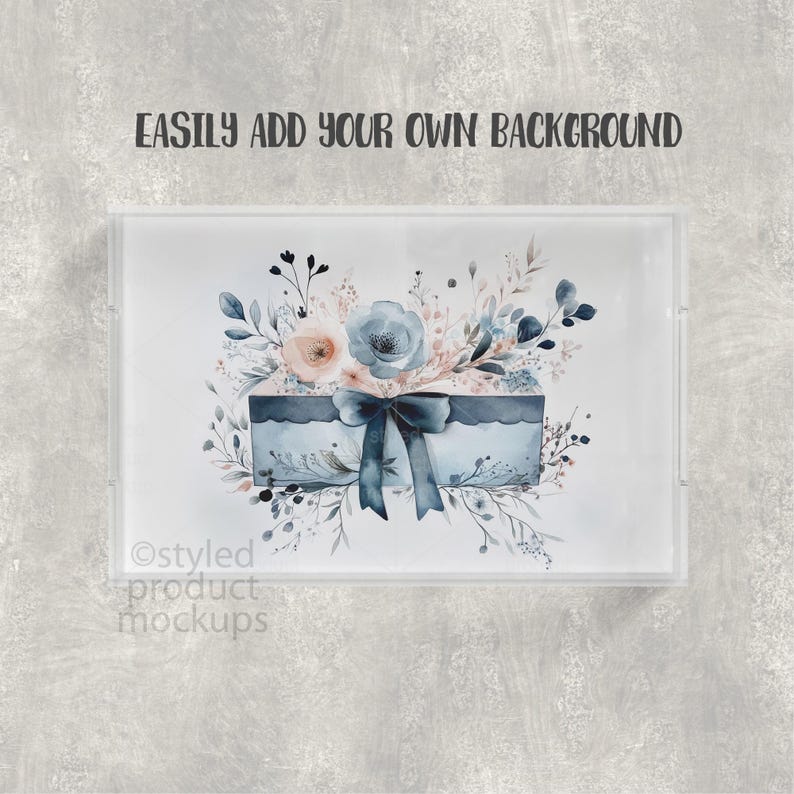 May include: A clear acrylic tray with a watercolor design. The design features a blue box with a bow, surrounded by blue and peach flowers and foliage. The text "EASILY ADD YOUR OWN BACKGROUND" is at the top.