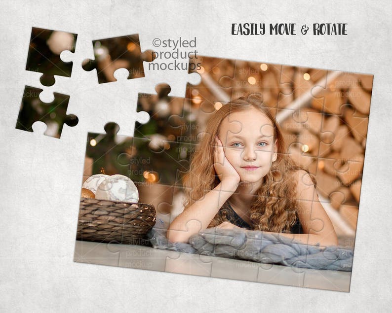May include: A young girl with long brown hair is lying on a blue blanket. She is looking at the camera with a smile. The background is a blurred image of a wooden wall with lights. The image is a jigsaw puzzle with some pieces missing.