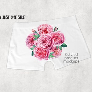 May include: White underwear with a pink floral print of roses. The print is on one side of the underwear. The text "@styled product mockups" is on the other side.