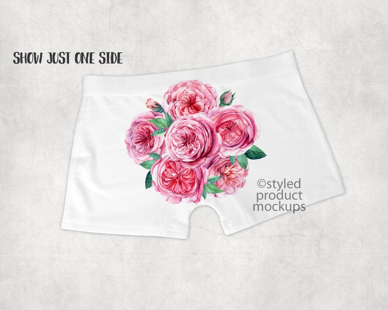 May include: White underwear with a pink floral print of roses. The print is on one side of the underwear. The text "@styled product mockups" is on the other side.