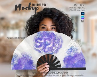 May include: A white folding fan featuring a central purple circular graphic with the letters SPM in bold white font. The fan has black ribs and is displayed with purple watercolor-style splatters on the left and right sides of the fabric.