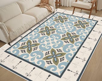 May include: A rectangular area rug featuring a repeating pattern of light blue and olive green floral motifs on a cream background. The rug has a dark blue border and a secondary outer border decorated with small, repeating black line art symbols.