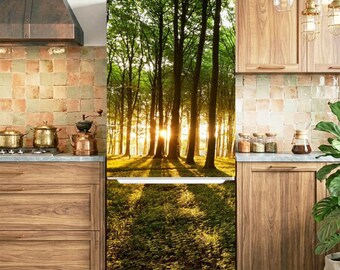 May include: A refrigerator featuring a full-length photographic wrap of a sunlit forest scene. The image displays tall trees with green leaves and golden sunlight filtering through the branches onto a forest floor covered in low-lying vegetation.
