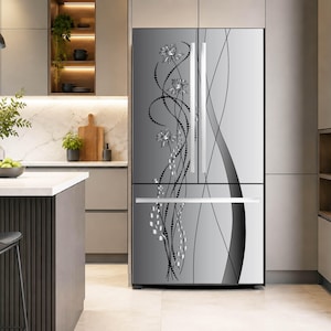 May include: A stainless steel French door refrigerator featuring a decorative black and silver floral graphic design on the front panels. The appliance has vertical handles on the upper doors and a horizontal handle on the bottom freezer drawer.