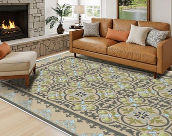 May include: A rectangular area rug featuring a repeating tile-inspired pattern in shades of sage green, light blue, and dark charcoal on a beige background, with a decorative border and the text LA-PAZ printed in the bottom right corner.