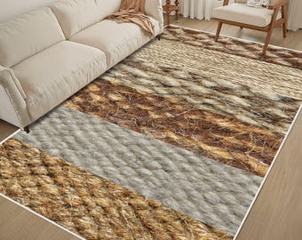 May include: A rectangular area rug featuring a series of wide, horizontal bands with varying textures and patterns in shades of beige, tan, brown, and cream, mimicking the appearance of woven natural fibers and thick, twisted rope.