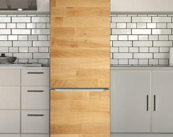 May include: A refrigerator with a light wood grain finish. The two-door appliance is set in a kitchen with white cabinets and a white tile backsplash. The refrigerator has a stainless steel handle.