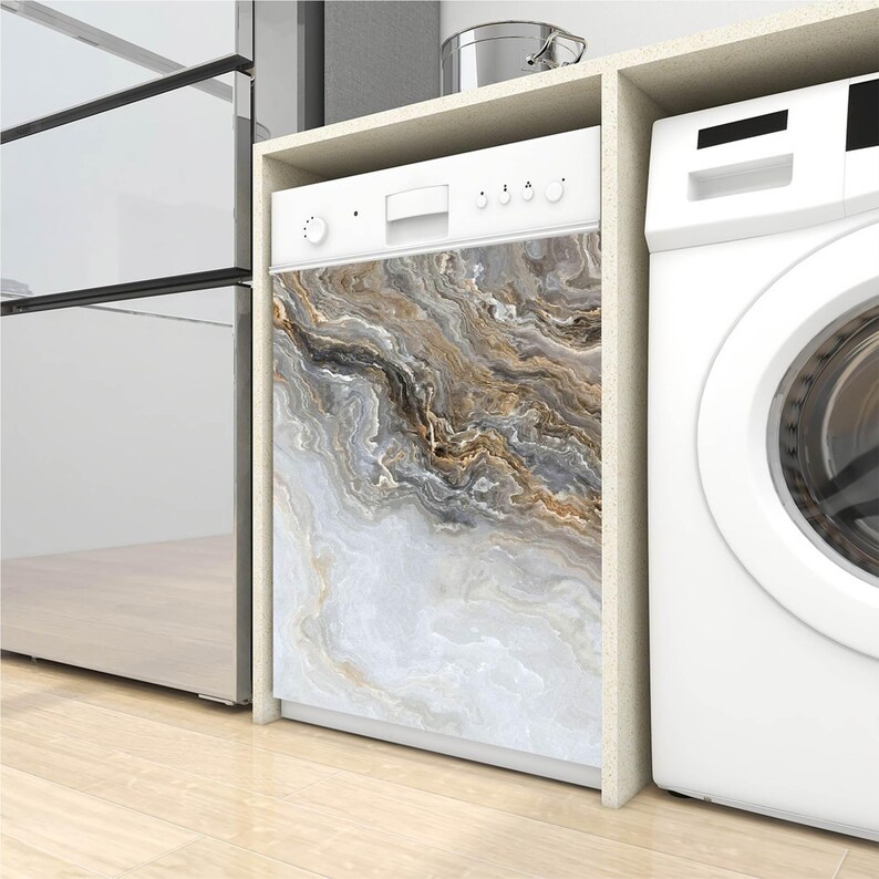 May include: A white dishwasher with a decorative front panel featuring a marble-like design in shades of white, gray, and brown. The appliance is built into a kitchen cabinet next to a white washing machine.