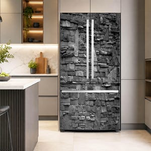 May include: A French door refrigerator featuring a full-coverage adhesive wrap with a high-resolution print of a dark gray stacked stone wall pattern. The appliance has two vertical silver handles on the upper doors and one horizontal silver handle.