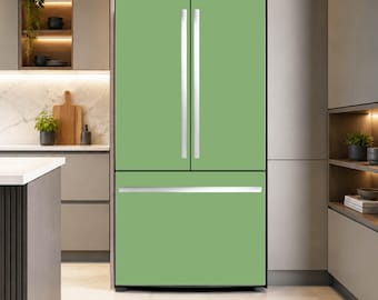 May include: A sage green French door refrigerator featuring two vertical doors on top and a single pull-out freezer drawer at the bottom. The appliance has long, slim, silver-toned metal handles on each door and the freezer drawer.