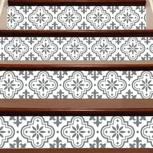 May include: Staircase with decorative tile stickers. The stickers feature a repeating gray and white floral pattern. The stairs have dark brown wooden steps and risers. The design adds a decorative element to the home.