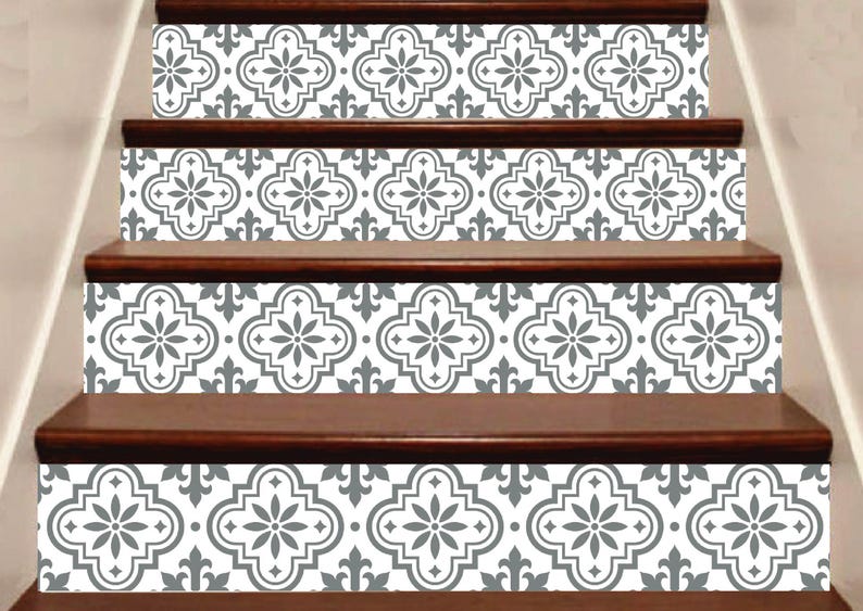 May include: Staircase with decorative tile stickers. The stickers feature a repeating gray and white floral pattern. The stairs have dark brown wooden steps and risers. The design adds a decorative element to the home.
