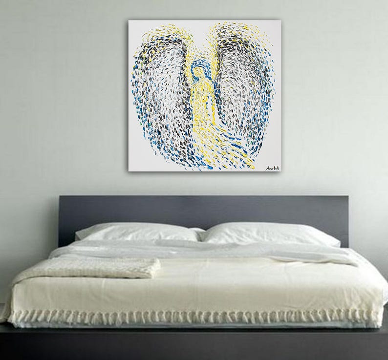 May include: Abstract painting of an angel with blue and yellow paint splatter on a white background.
