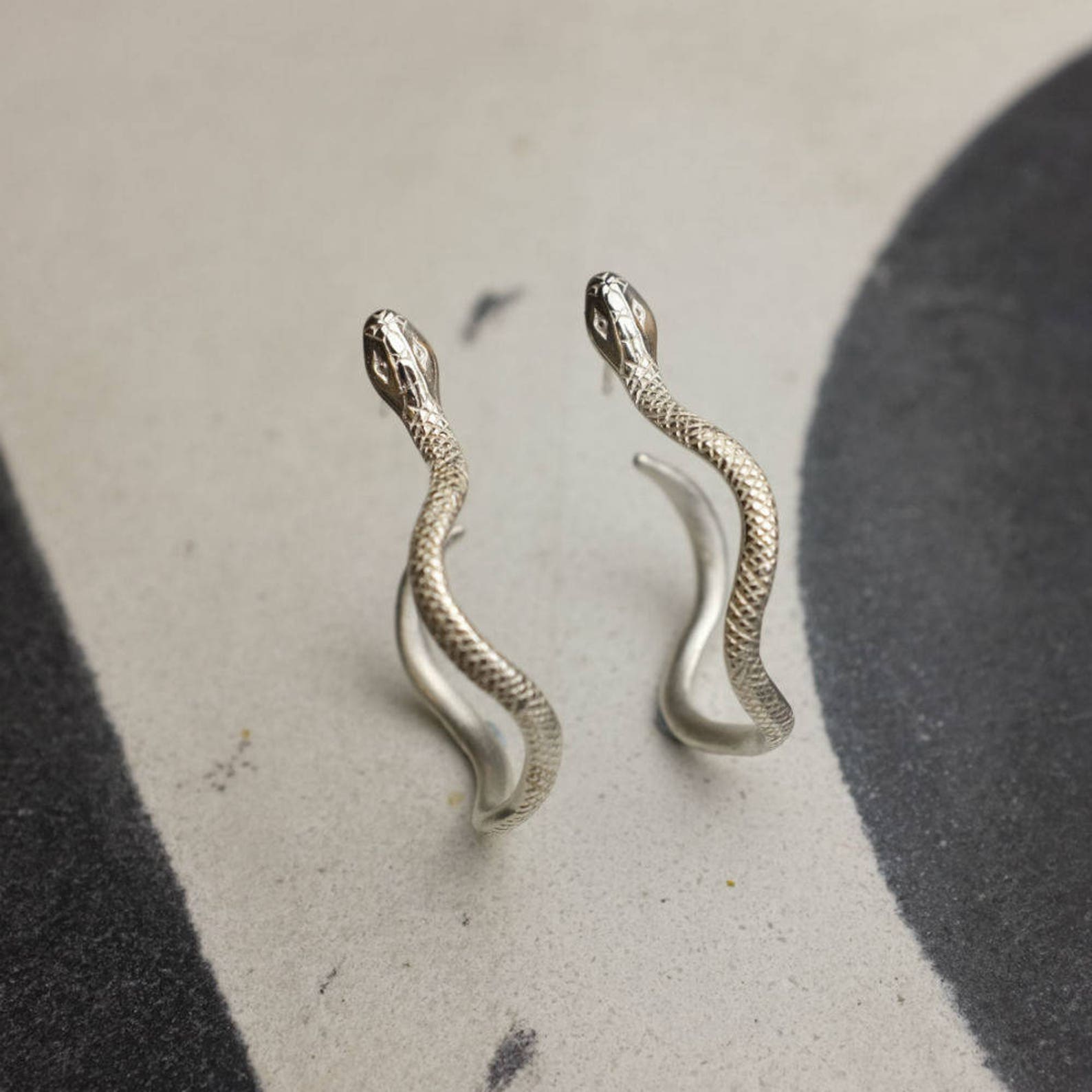 black snake hoop earrings
