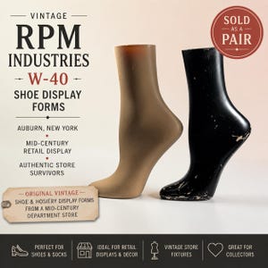 May include: Two foot-shaped shoe display forms, one in a matte tan finish and one in a glossy black finish with visible surface wear. The text VINTAGE RPM INDUSTRIES W-40 SHOE DISPLAY FORMS AUBURN, NEW YORK MID-CENTURY RETAIL DISPLAY is present.