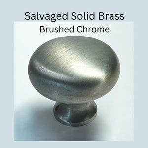 May include: Brushed chrome cabinet knob with a rounded top and a cylindrical base. The knob is made of salvaged solid brass. The text "Salvaged Solid Brass" and "Brushed Chrome" are displayed above the knob.