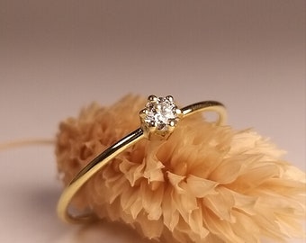 delicate romantic engagement ring with diamond in claw setting