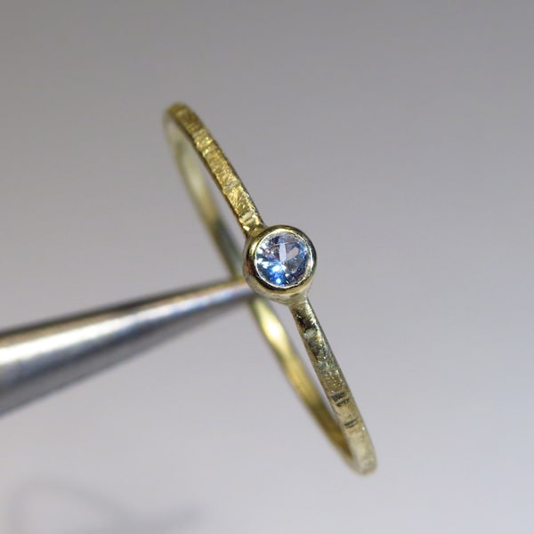 delicate, handmade engagement ring in gold with sapphire