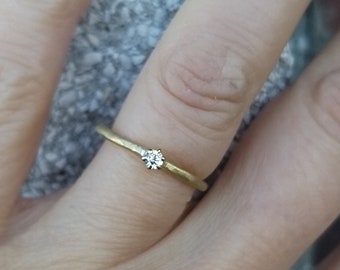 forged engagement ring in gold with diamond in claw setting