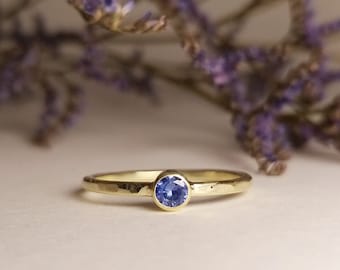 simple romantic engagement ring with sapphire, in yellow gold - light hammer finish