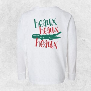 May include: White long-sleeve t-shirt with a green alligator and the text "Heaux Heaux Heaux" in red.