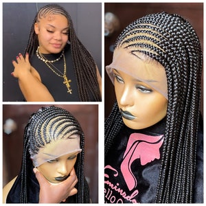 May include: A black braided wig with a lace front. The wig is styled in a straight, long style with a part on the side. The wig is on a mannequin head.