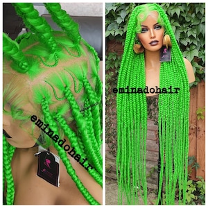 May include: A bright green braided wig with long, thick braids. The wig is styled with a side part and the braids are pulled back and secured with a hair tie. The wig is on a mannequin head and is set against a green background.