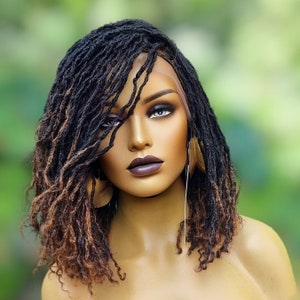 May include: A brown and black synthetic dreadlock wig with a lace front. The wig is styled in a side parting with loose, wavy curls.