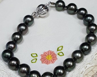 Genuine Tahitian black pearl bracelet with 14kt white gold clasp.