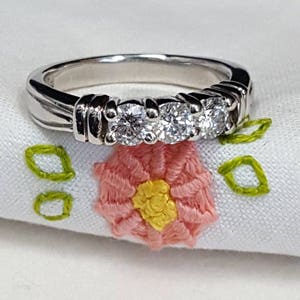 Platinum and diamond ring custom design with 3 round brilliant cut diamonds weighing .60ct. total in a heavy 9 gram band.