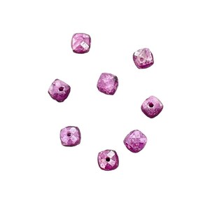 May include: Eight magenta-coloured, square-cut beads with facets. Each bead has a central hole, suitable for stringing. The beads are scattered on a plain white background, showcasing their individual shapes and colour.