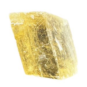 May include: A golden-yellow selenite crystal with a translucent appearance. The mineral has a rough, textured surface with visible internal striations and a slightly angled, rectangular shape. The crystal is isolated against a white background.