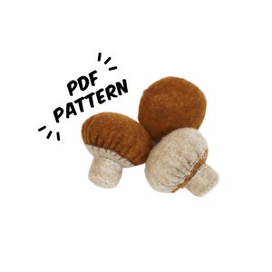 May include: Three felt mushroom toys in brown and beige colors. The mushrooms are arranged in a cluster. The image includes the text "PDF PATTERN".